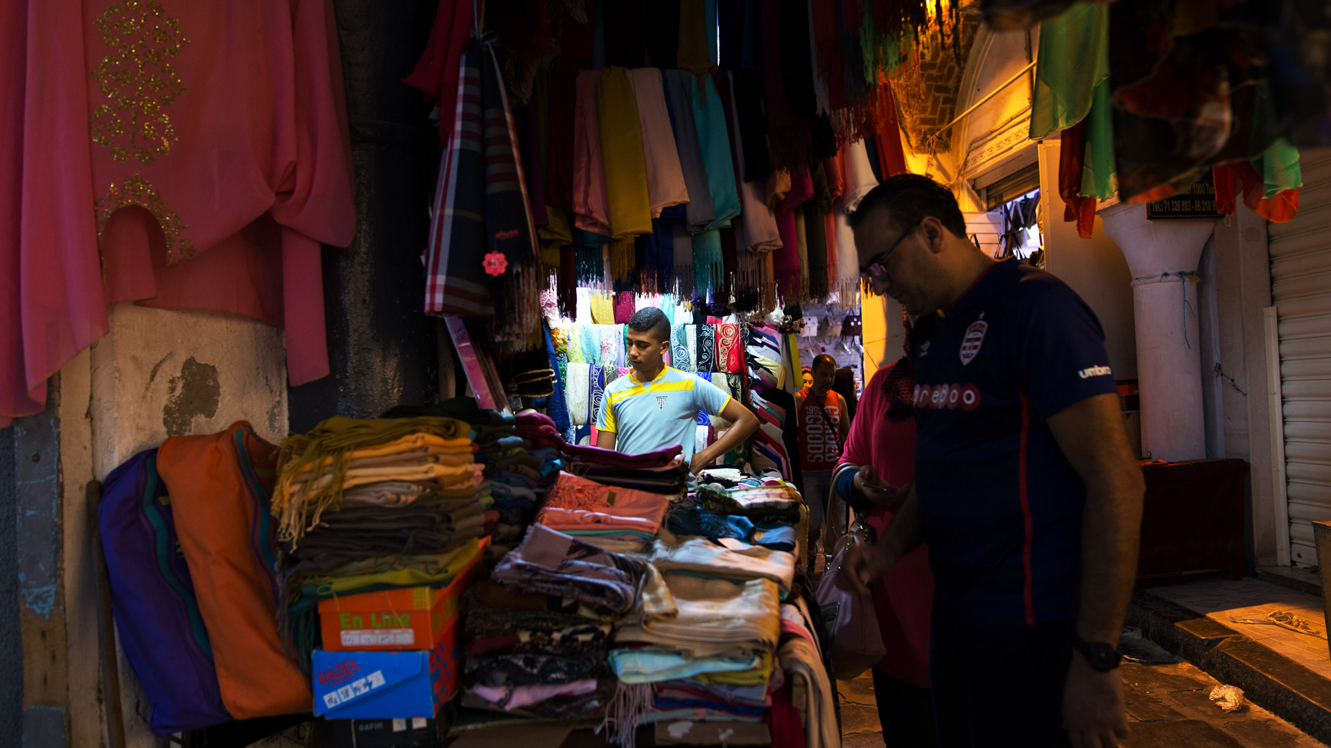A man examines wares in the souk in Tunis' old city. 