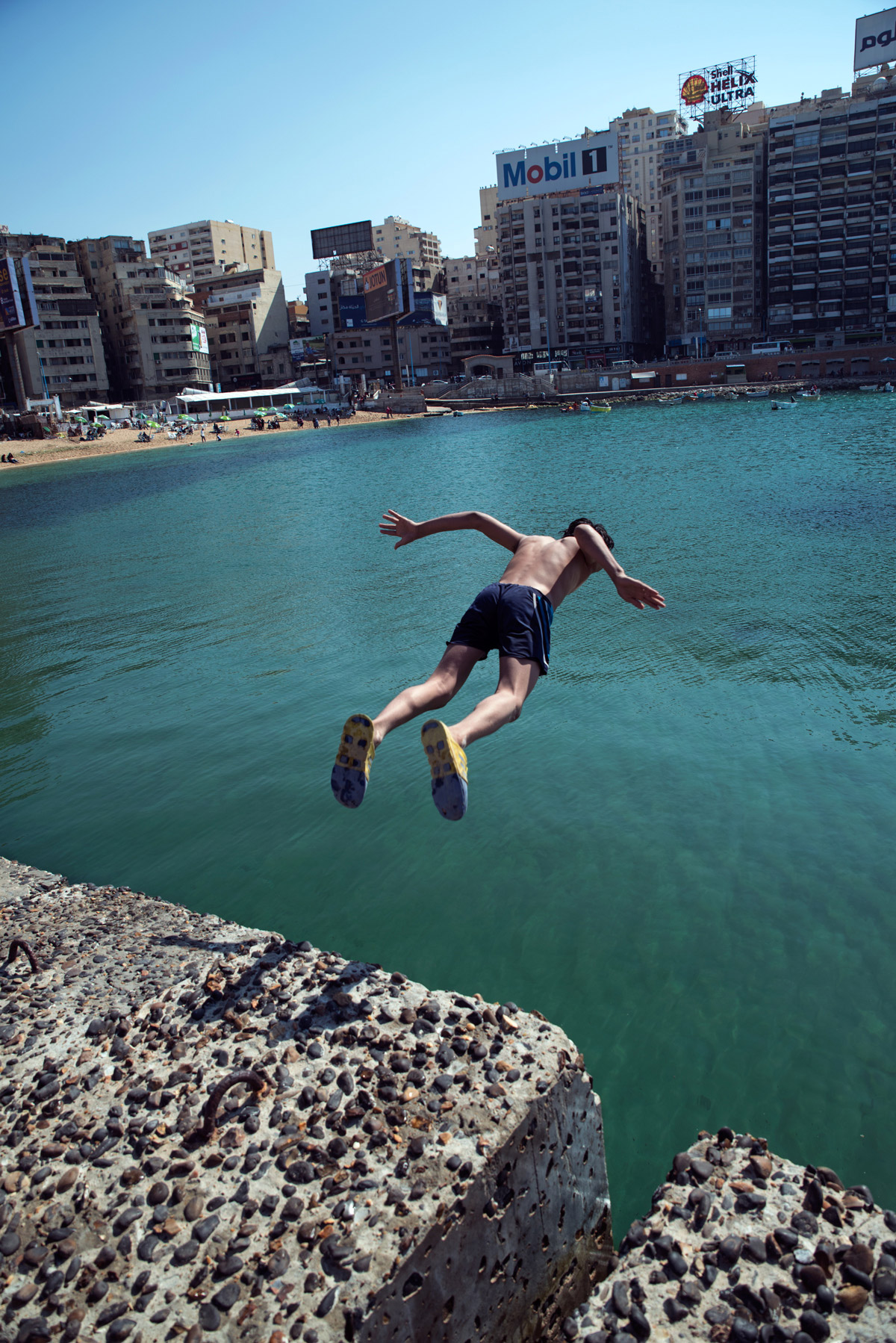 A boy jumps into the sea at Gleem Beach.