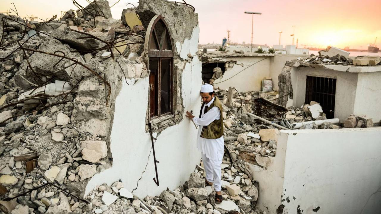Abubaker surveying the ruins of Sidi Shaab mosque after it was destroyed in an attack by Salafi militants. 